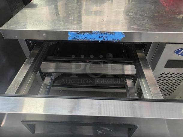 Atosa MGF8448GR 36″ refrigerated chef base with stainless steel top, visible blue tape label indicating model details.