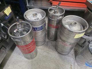 Lot of 4 metal kegs with tap fittings. Each keg features different brewery branding and appears in used condition.