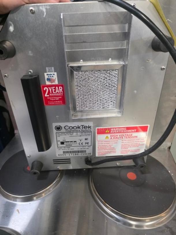 Cooktek MC1500 single burner induction cooktop, 1500W. Displays "ERROR CODE 02". Visible label indicates warranty and safety information.