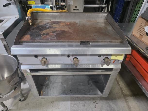 CPG 36" gas countertop griddle with Regency stainless steel open base stand, used condition, visible rust on griddle surface.