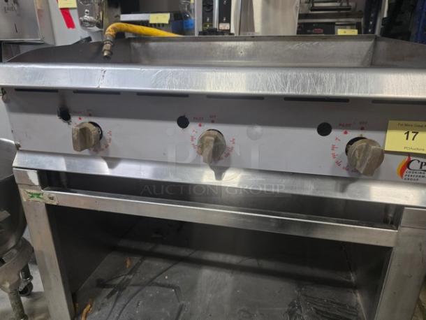 CPG 36" gas countertop griddle on Regency 36" stainless steel open base stand, features control knobs, visible wear.