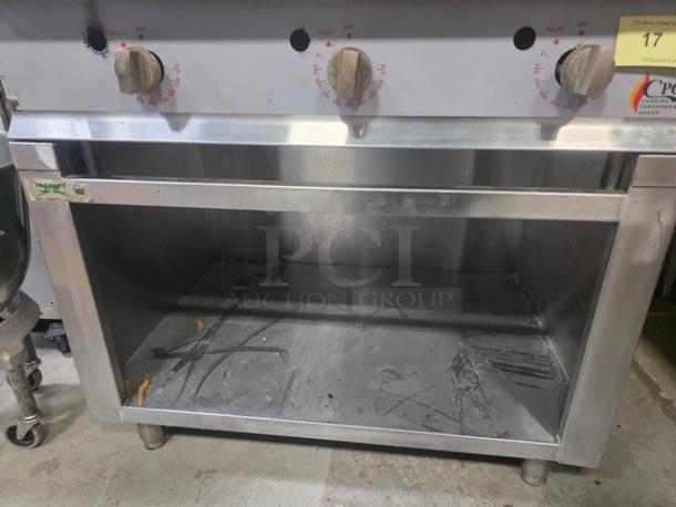 CPG 36" gas countertop griddle with Regency 36" stainless steel stand, visible knobs, and pilot settings, in used condition.