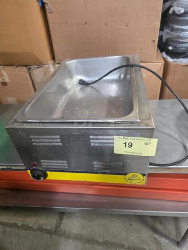 Qualite full-size electric countertop food warmer, stainless steel, visible power cord, dial control, in used condition.