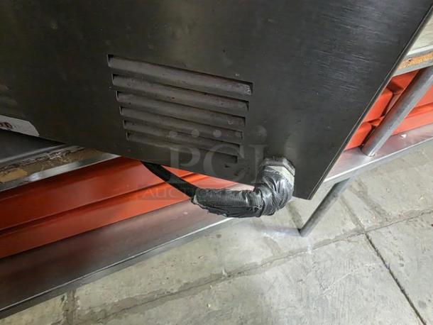 Qualite full-size electric countertop food warmer, vented design, visible wear on power cord, good condition.