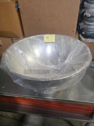Stainless steel punch bowl wrapped in plastic, vivid shine, excellent condition, auction tag marked "20."