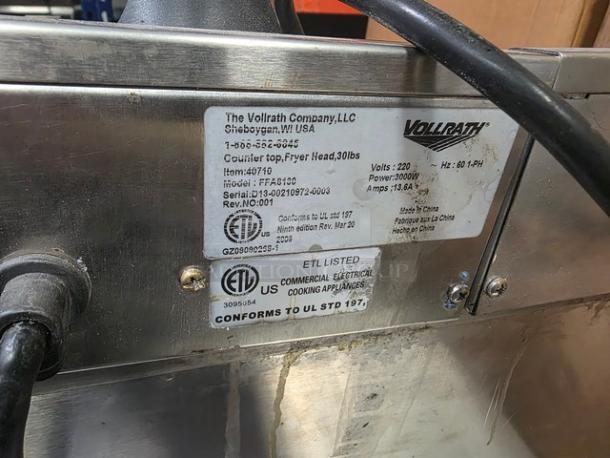 Vollrath Countertop Fryer FFA8130, 30lb capacity, 220V, 60Hz, 1 PH, stainless steel, ETL listed. Tag shows model and specs.