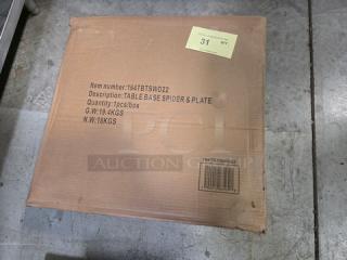 Brown cardboard box labeled "Table Base Spider & Plate." Item number: 164TBTSWD22. Quantity: 1 piece. Gross weight: 19.4 KGS. Net weight: 18 KGS.