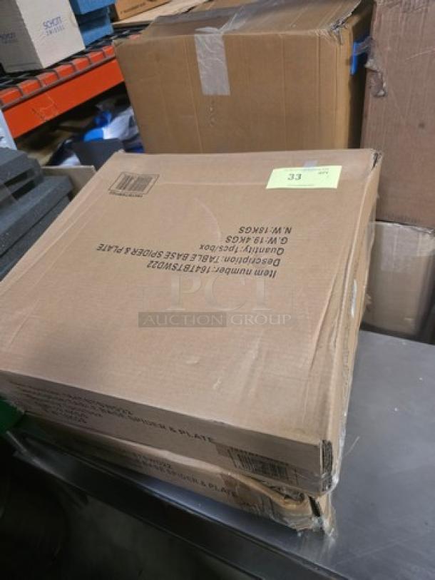 Cardboard box labeled "Table Base Spider & Plate," item number F167SUD02, in good condition, stack of two boxes on a metal surface.