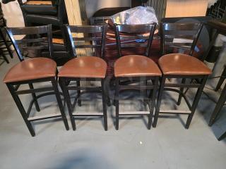 Set of four bar stools with dark wooden frames and brown cushioned seats. Good condition, sleek modern design.