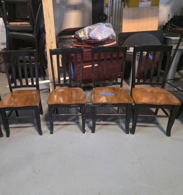Lot of 4 dining chairs with wooden seats and black slatted backs. Used condition, ideal for dining room or kitchen.