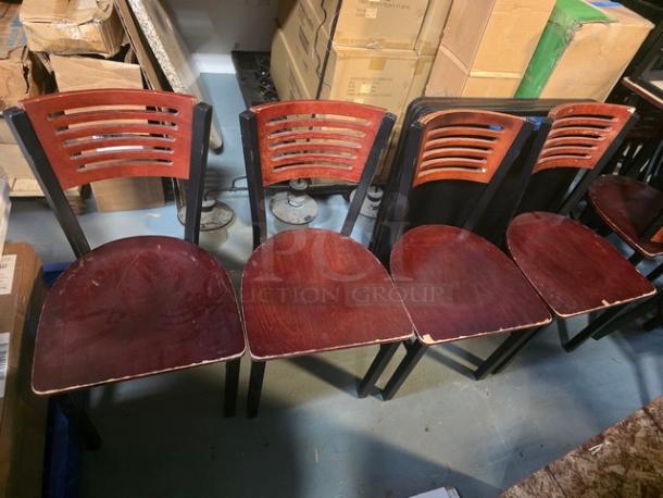Lot of 4 wooden dining chairs with slatted backs, dark wood finish, visible wear on seats and edges. Suitable for restoration.