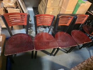 Lot of 4 wooden dining chairs with slatted backs, dark wood finish, visible wear on seats and edges. Suitable for restoration.