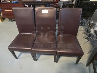 Lot of 3 brown dining chairs with cushioned seats and backs. Some visible wear on upholstery. Label with "3XBID" on one chair.