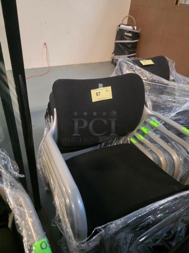 Lot of 5 stacking chairs with black fabric seats and gray powder-coated frames. Item labeled as "67." Good condition.
