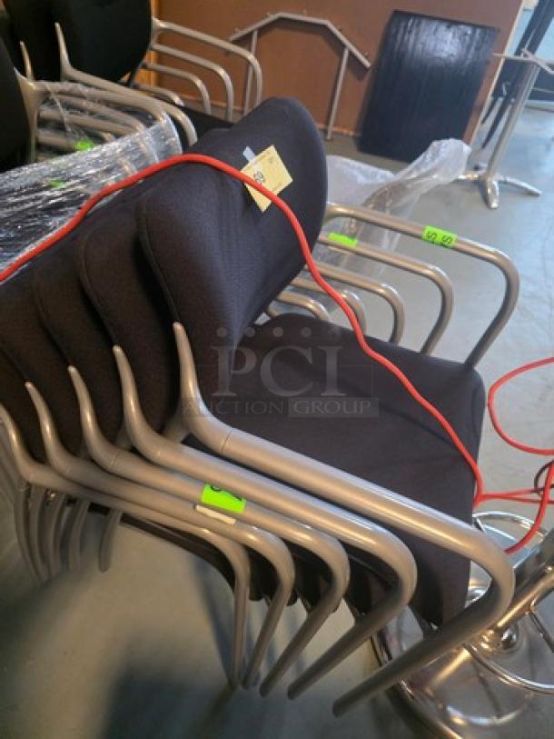 Lot of 5 stacking chairs with black fabric seats and gray powder-coated frames. Good condition, ideal for office use.