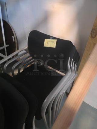 Lot of 5 stacking chairs with black fabric seats and gray powder-coated frames, in used condition. Tag marked “71” visible.