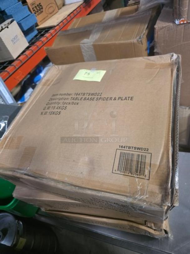Box containing a Table Base Spider & Plate, item number 164TBTSWD22, weighs 16 kg, shown in warehouse setting.