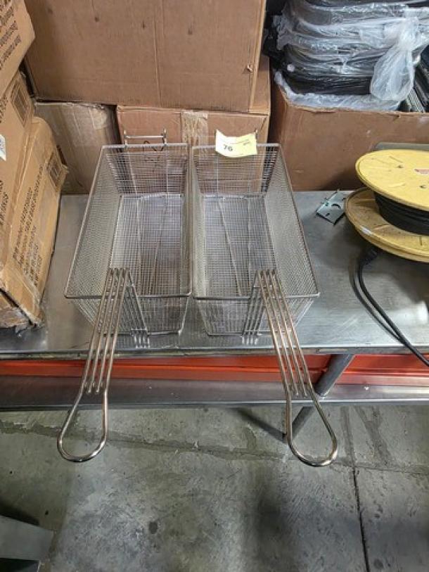 Lot of 2 stainless steel fry baskets with wire mesh, long handles, and numbered tag. Suitable for commercial use.