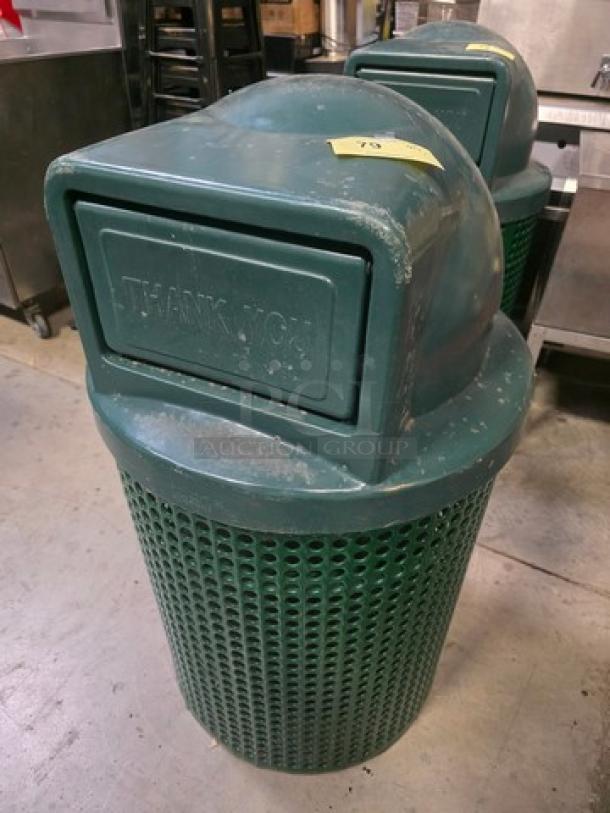 Large green trash receptacle with dome lid. Features a "Thank You" sign. Displays wear. Ideal for public spaces.