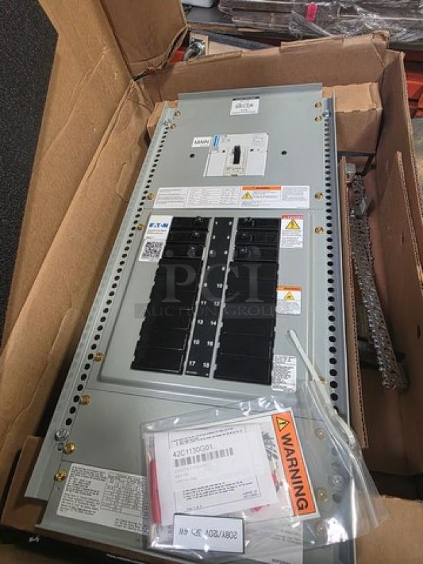 Eaton Pow-R-Line Xpert PRL1X panelboard in box, includes warning labels and instruction manual.