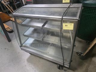 Vendo HFD000006 35" Hot Food Display Case, glass and metal, three shelves, caster wheels, good condition, inventory tag.