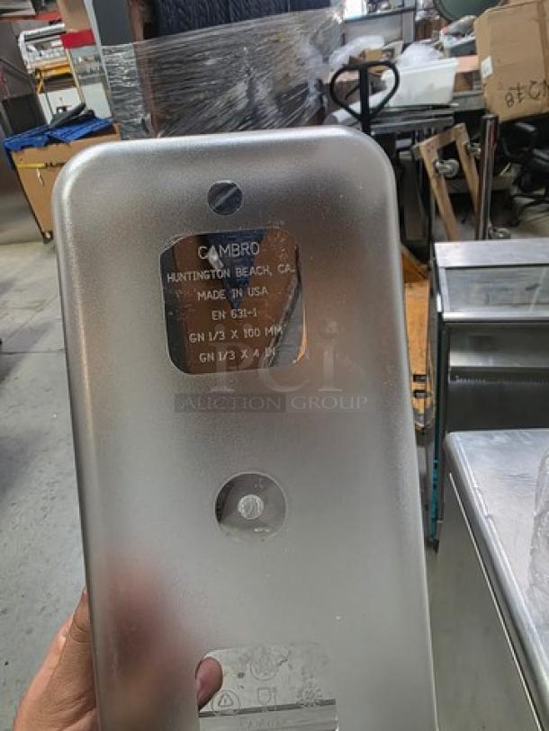 Lot of 13 Cambro plastic food pans, includes 5 lids. Marked "Made in USA." Condition suggests used but functional.