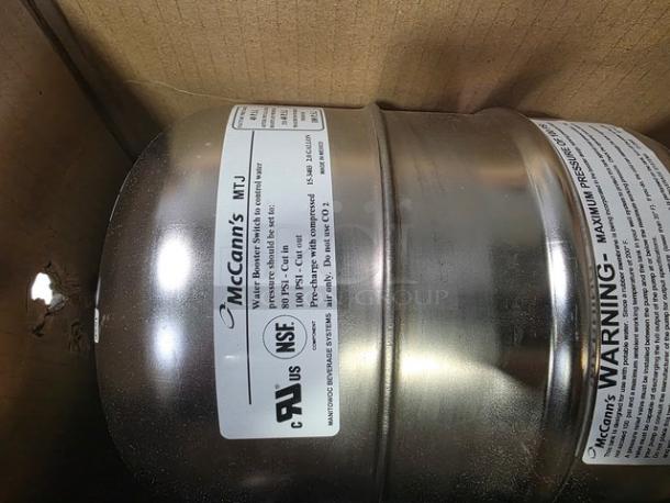 McCann's MTJ Water Booster System, silver stainless steel tank, NSF certified, warning label visible, excellent condition.