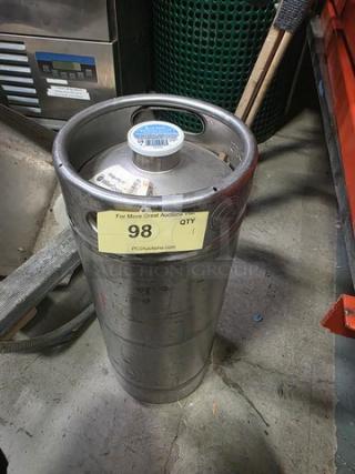 Stainless steel keg with label indicating auction item 98. Used condition with visible markings and cap seal intact.