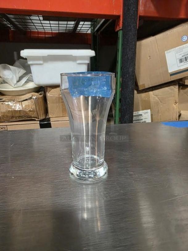 Libbey 8 oz pilsner glass, clear design, on a metal surface. Boxes visible in background.