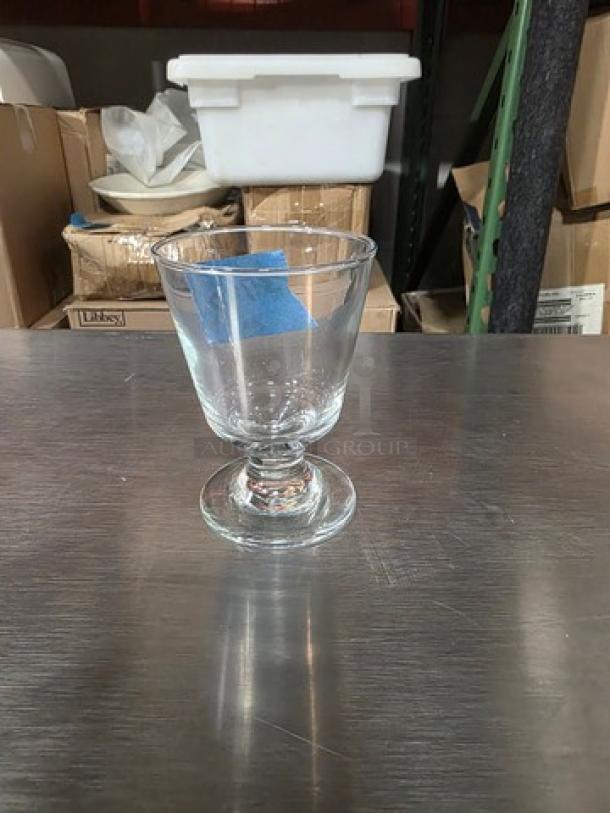 Libbey 3747 Embassy 7 oz footed rocks glass, clear glass, excellent condition, displayed on a metallic surface.