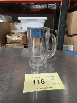 Clear glass beer mug with handle, vertical grooves, in good condition. Quantity: one lot. Auction tag visible for item identification.