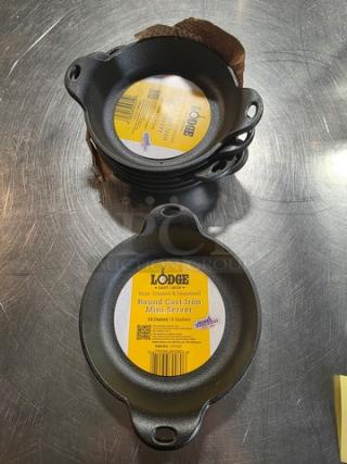 Lot of 6 Lodge round cast iron mini servers, 14-ounce capacity, pre-seasoned, excellent condition, with visible labels.