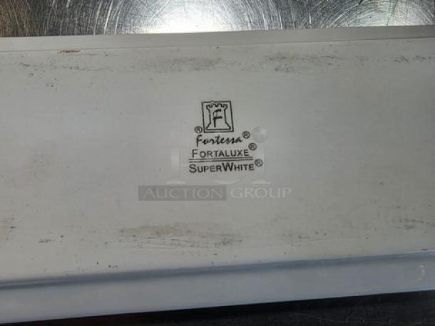 Lot of 40 Fortessa Fortaluxe SuperWhite rectangle platters, lightly used, showing back markings with brand and model details.