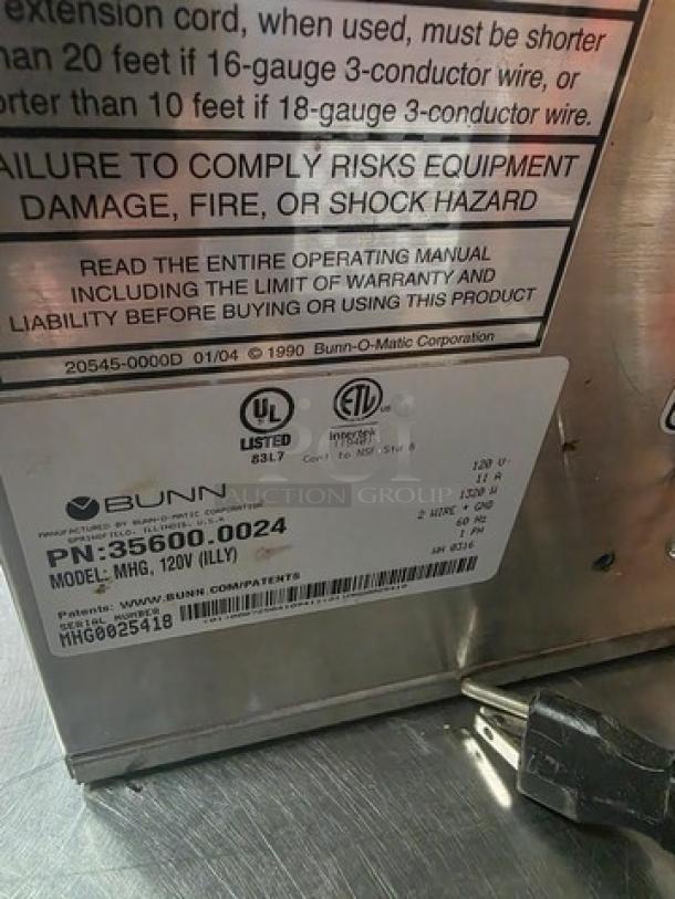 Bunn MHG Multi-Hopper Coffee Grinder, Model MHG, metal body, visible label with serial number and electrical specifications.