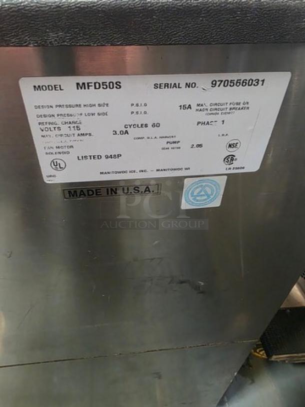 Manitowoc MFD50S Ice Cube Dispenser, 115V, 60Hz, 1 PH. Features stainless steel body, model and serial number visible. Made in USA.