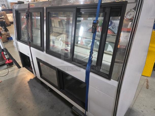 Marc Refrigeration 94" self-contained butcher meat display with glass doors, in good condition, showing internal shelving and thermometer.