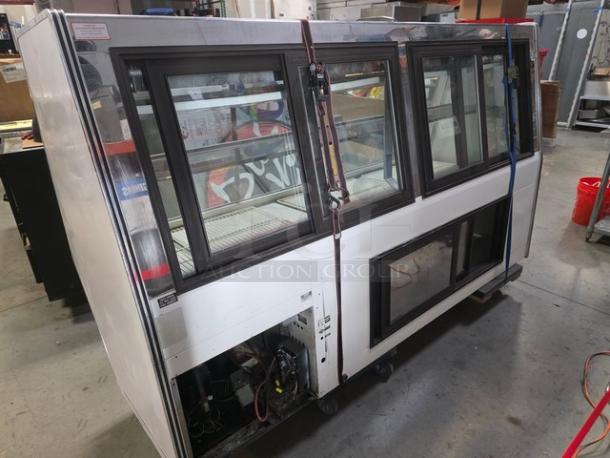 Marc Refrigeration 94" self-contained butcher meat display, glass doors, steel frame. Condition: used. Internal shelving visible.