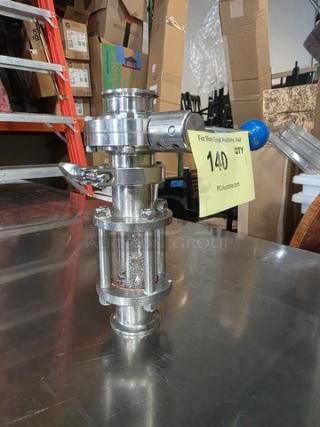 Stainless steel dry hopper assembly, cylindrical design, features clamps and sight glass, in new condition, labeled for auction.