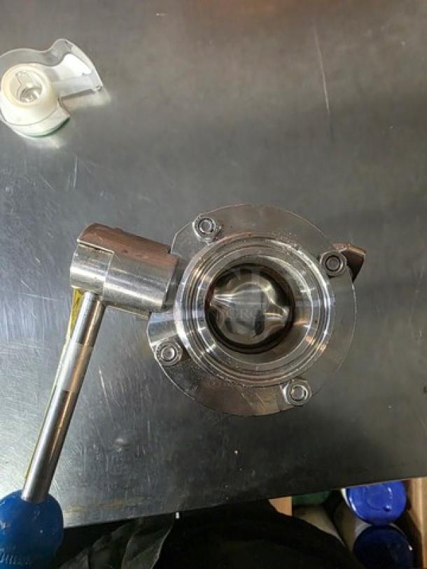 Stainless steel dry hopper assembly, circular design, with visible valve. Excellent condition, shiny finish.