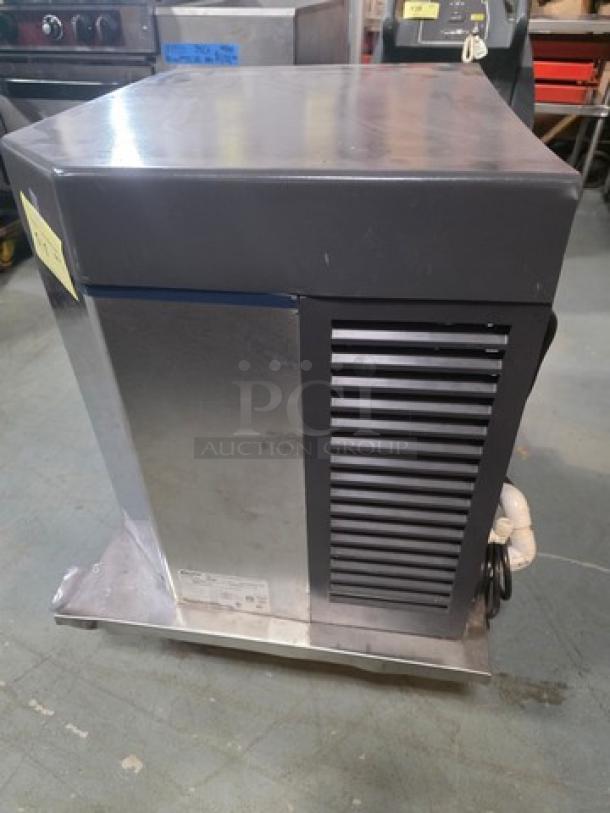 Follett HCC1000A self-contained ice machine, stainless steel, 208-230V, 1 PH, 60 Hz, up to 1000lbs capacity, visible model label.