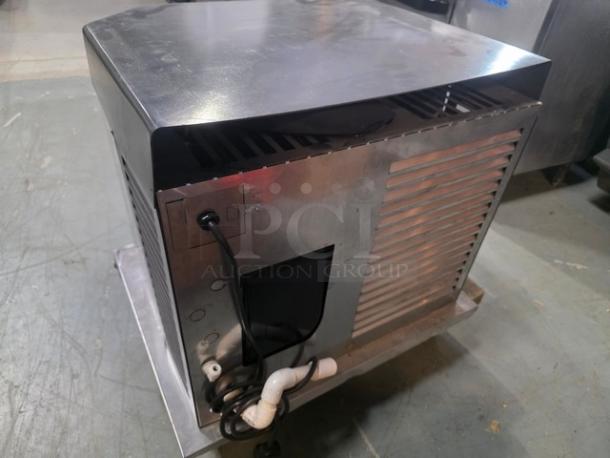 Follett HCC1000A ice machine, 208-230V, 1 PH, 60 Hz, up to 1000lbs capacity. Metal exterior, visible power cord.