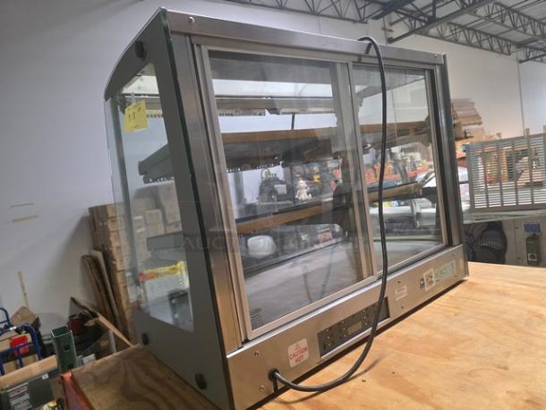 Sanden Vendo Hot Food Display Case, model HFD000006, 115V, 1PH. Features glass panels, adjustable shelves, in good condition.
