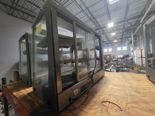 Sanden Vendo Hot Food Display Case, Model HFD000006, 115V, 1PH, glass panels, used condition, in a warehouse setting.