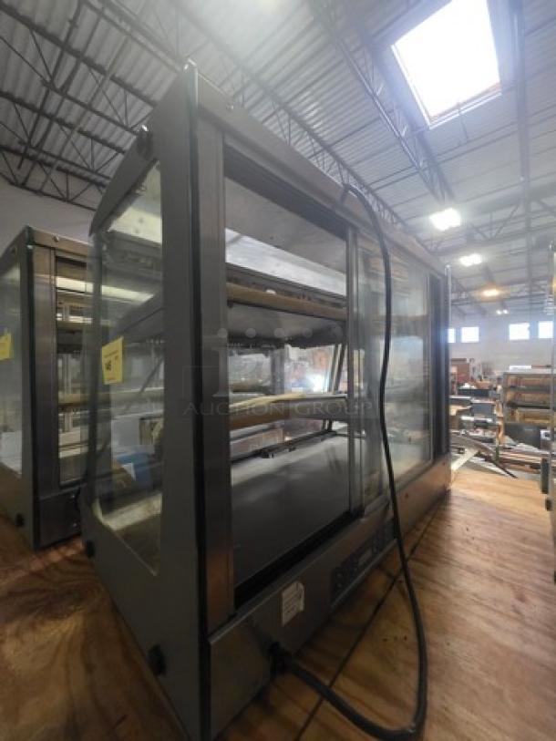 Sanden Vendo Hot Food Display Case, model HFD000006, 115V, 1PH, glass panels, metal frame, in a warehouse setting.