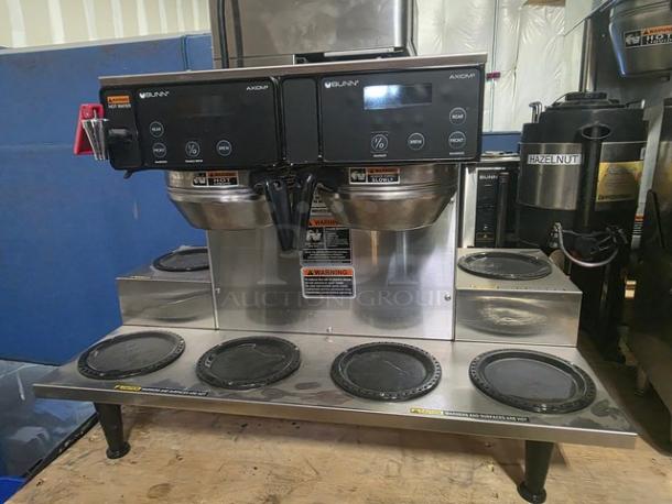Bunn Axiom 38700.0015 twin 12-cup coffee brewer with 6 lower warmers, stainless steel, digital controls, visible brand labels.