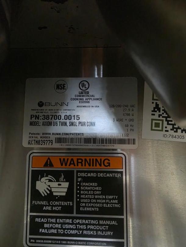 Bunn Axiom 0/6 Twin 12 Cup Coffee Brewer label with model 38700.0015 details and safety warning.