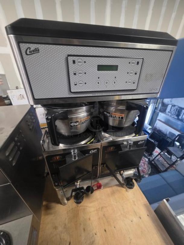 Curtis GEMXTIFT10A2000 twin coffee brewer with two lower warmers and hot water faucet. Features control panel, 220v/1PH.