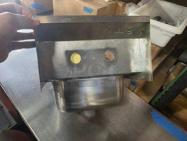 Stainless steel commercial wall-mount hand sink in good condition, features pre-drilled holes for faucet installation.