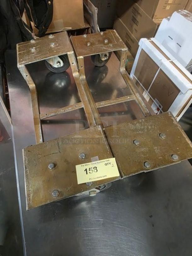 Lot of two heavy-duty piano dollies with metal frames and wheels, displaying wear; label shows "158, Qty 2".
