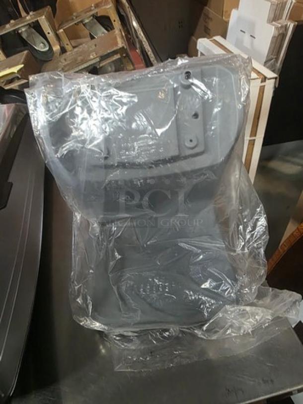Dixie Ultra Dispenser in new condition, wrapped in plastic. Made of durable material, designed for efficient dispensing.